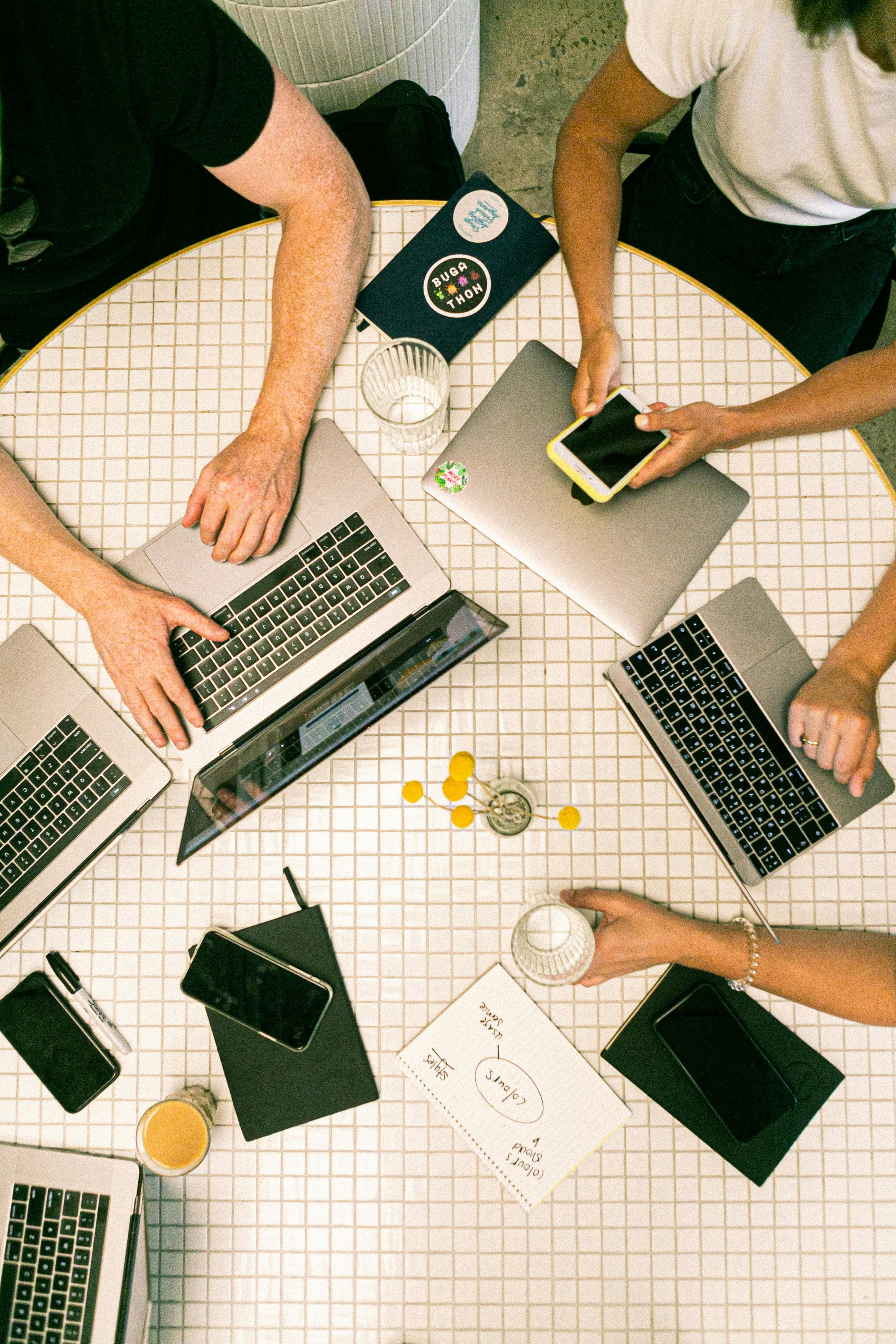 Top down view of people working on laptops